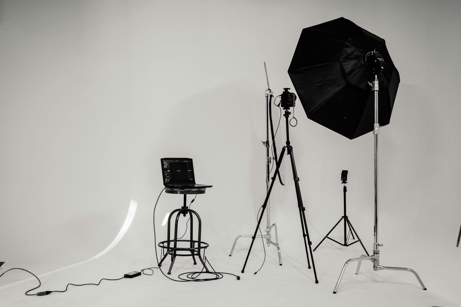 Studio floodlights set up in a professional photography environment with clean background.